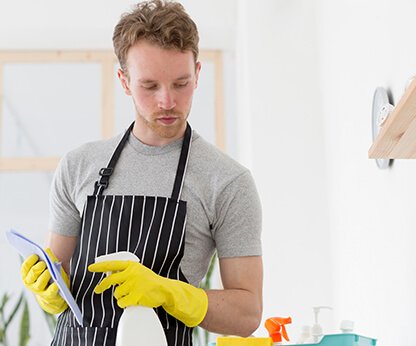 Cleaner hand-wiping dusty baseboards
